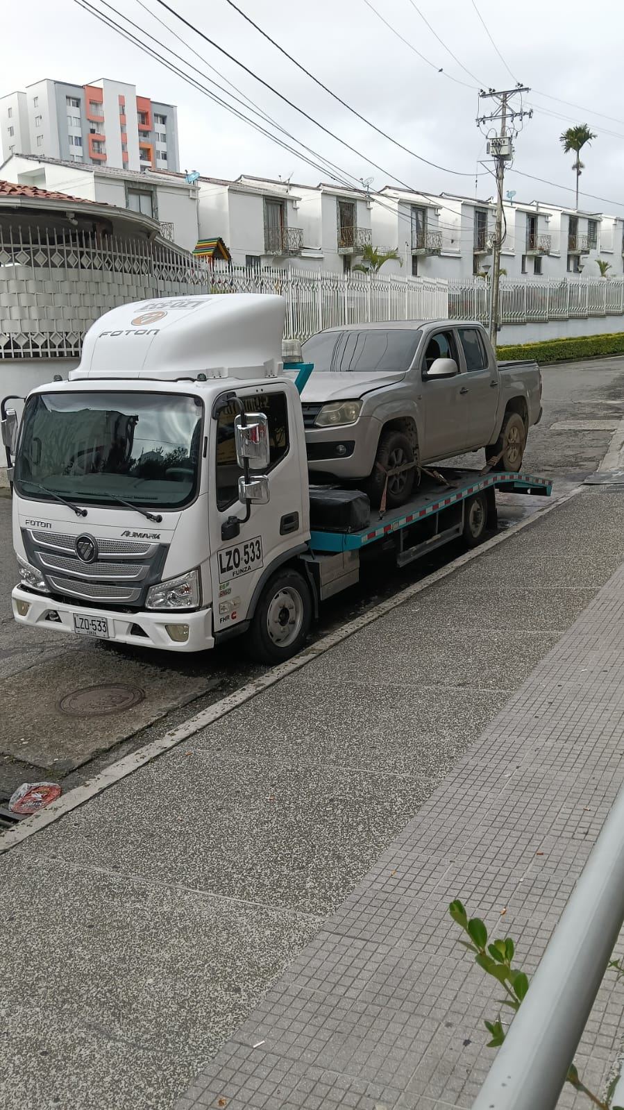 Grúa de plataforma Foton Aumark de Servigrúas Armenia transportando una camioneta